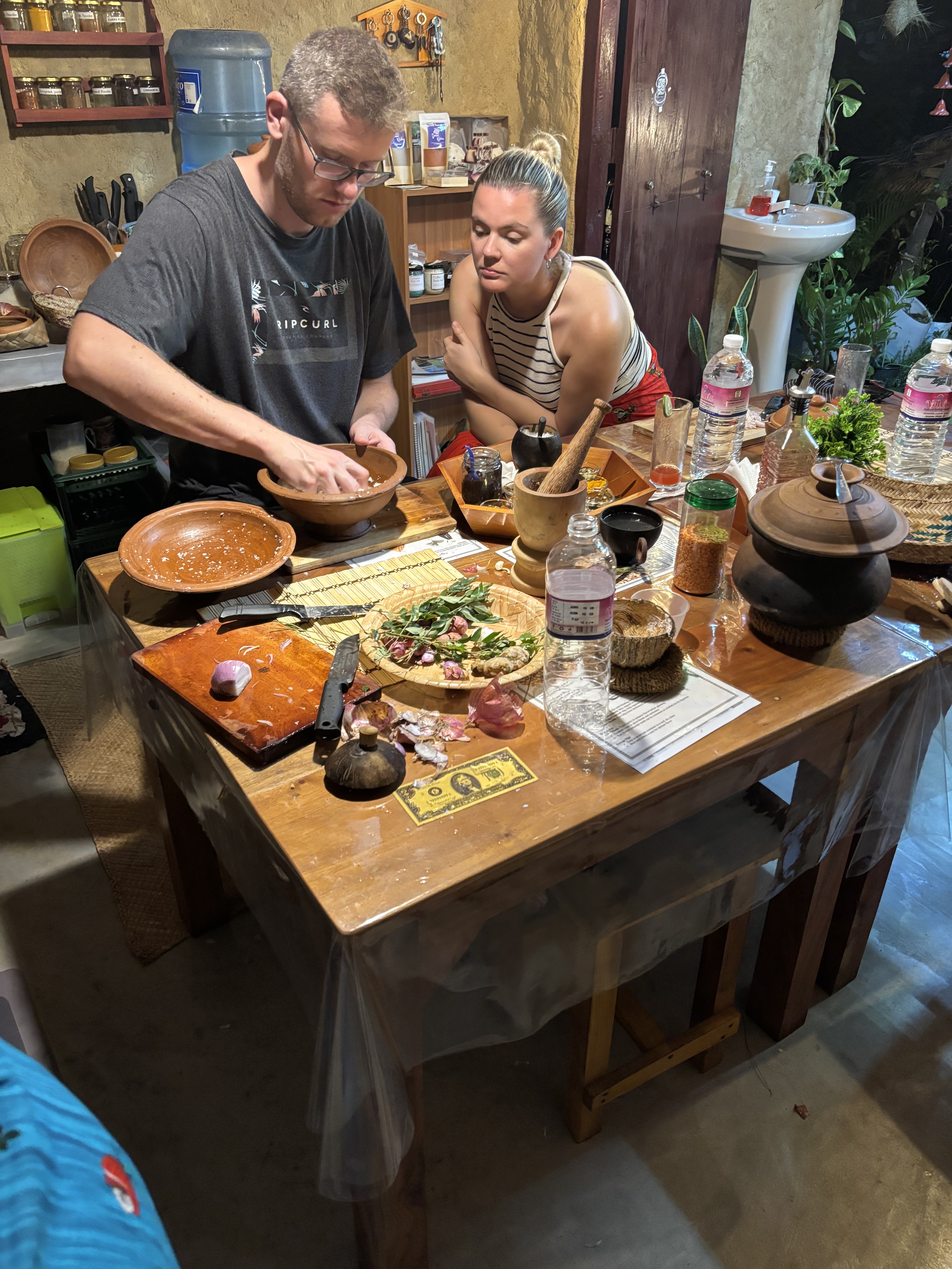 Hands-on cooking class — preparing local ingredients in clay bowls